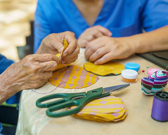 residents cutting and sticking shapes in an arts and crafts activity