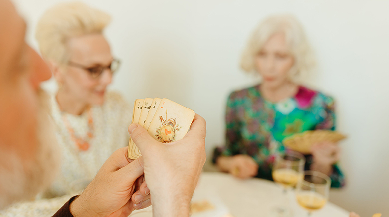 a group of elderly people playing a card game
