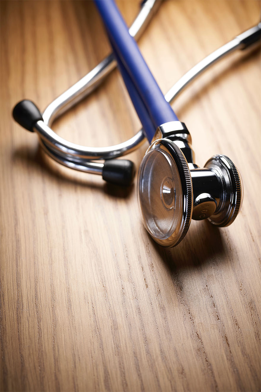 stethoscope on wooden table