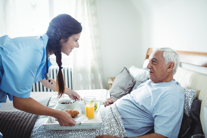 senior man being cared for in bed