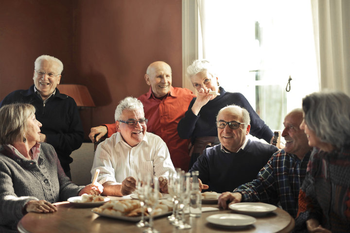 older people eating and laughing together